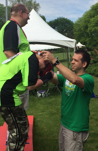 Windsor employee awards a medal at the Special Olympics