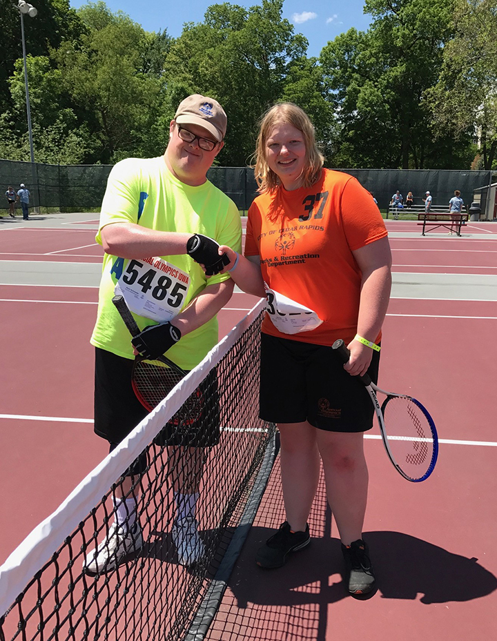 Athletes Shake Hands Before Tennis Match at Special Olympics