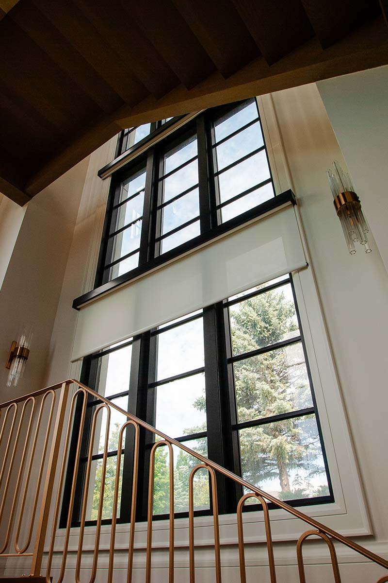 Stylish fixed window brightly illuminates stairwell
