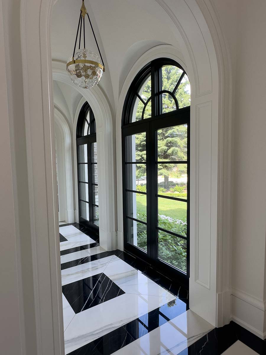 Pinnacle black clad fixed door panels with arched transoms